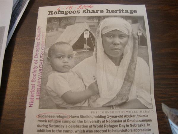 Newspaper clipping with Headline Refugees share heritage featuring Sudanes refugee Hawo Sheikh